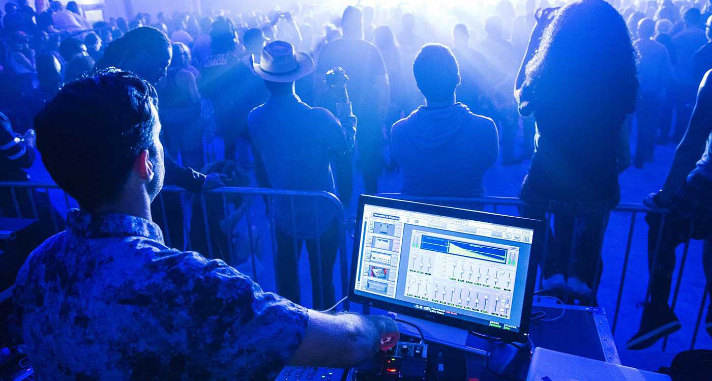 Andy Carrington working the live sound desk at a gig