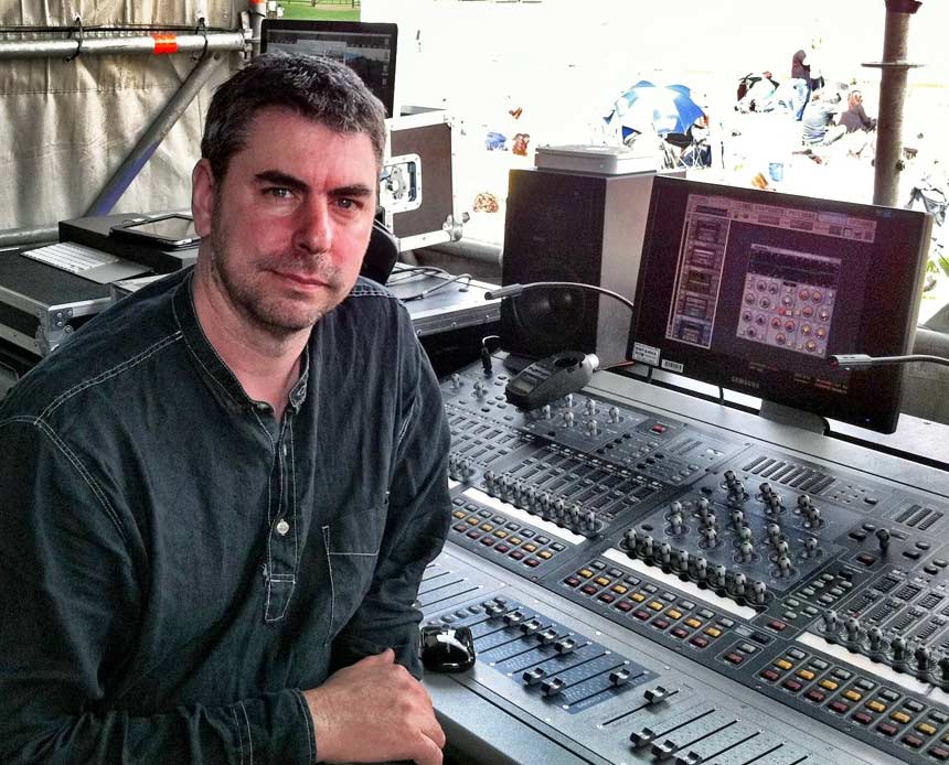 Ben Findlay sat at live sound desk at a festival