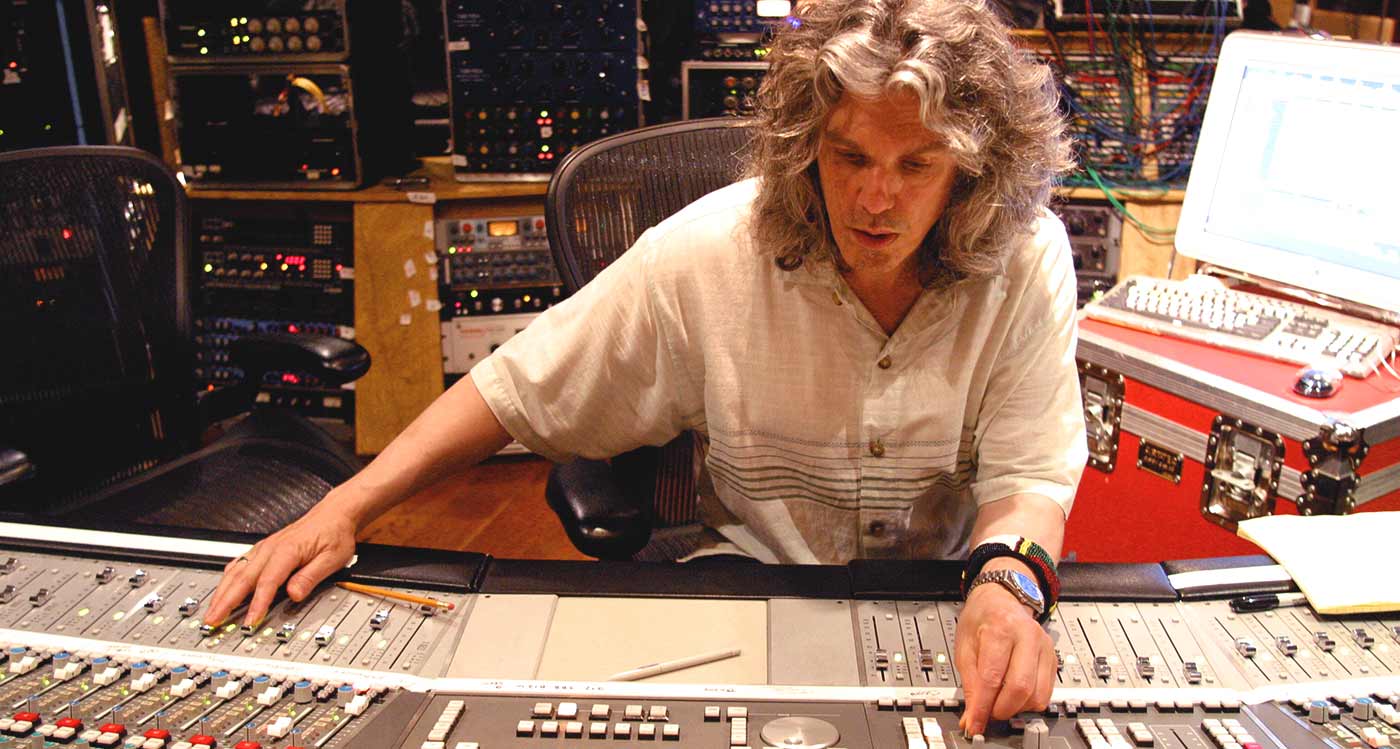 Bob Power using a mixing desk in a studio room