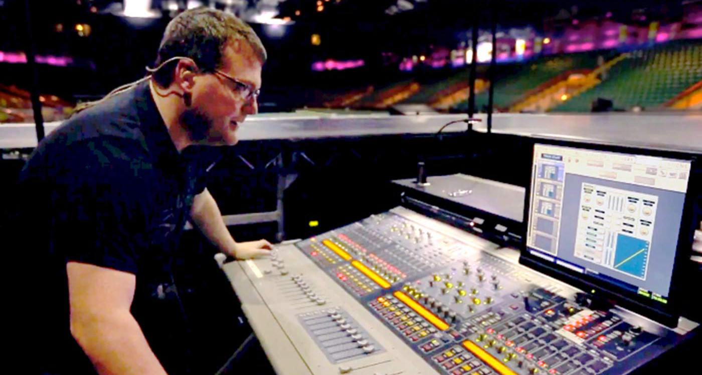 James Baker operating a monitor desk in an empty stadium preparing for a gig