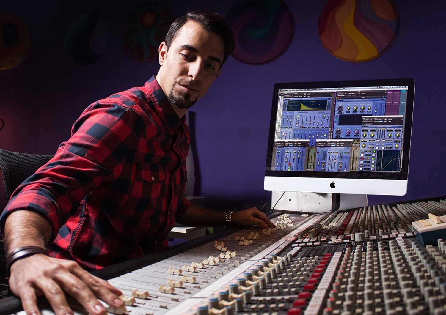 Matteo Marciano operating a mixing desk with Sonnox plugins on the screen