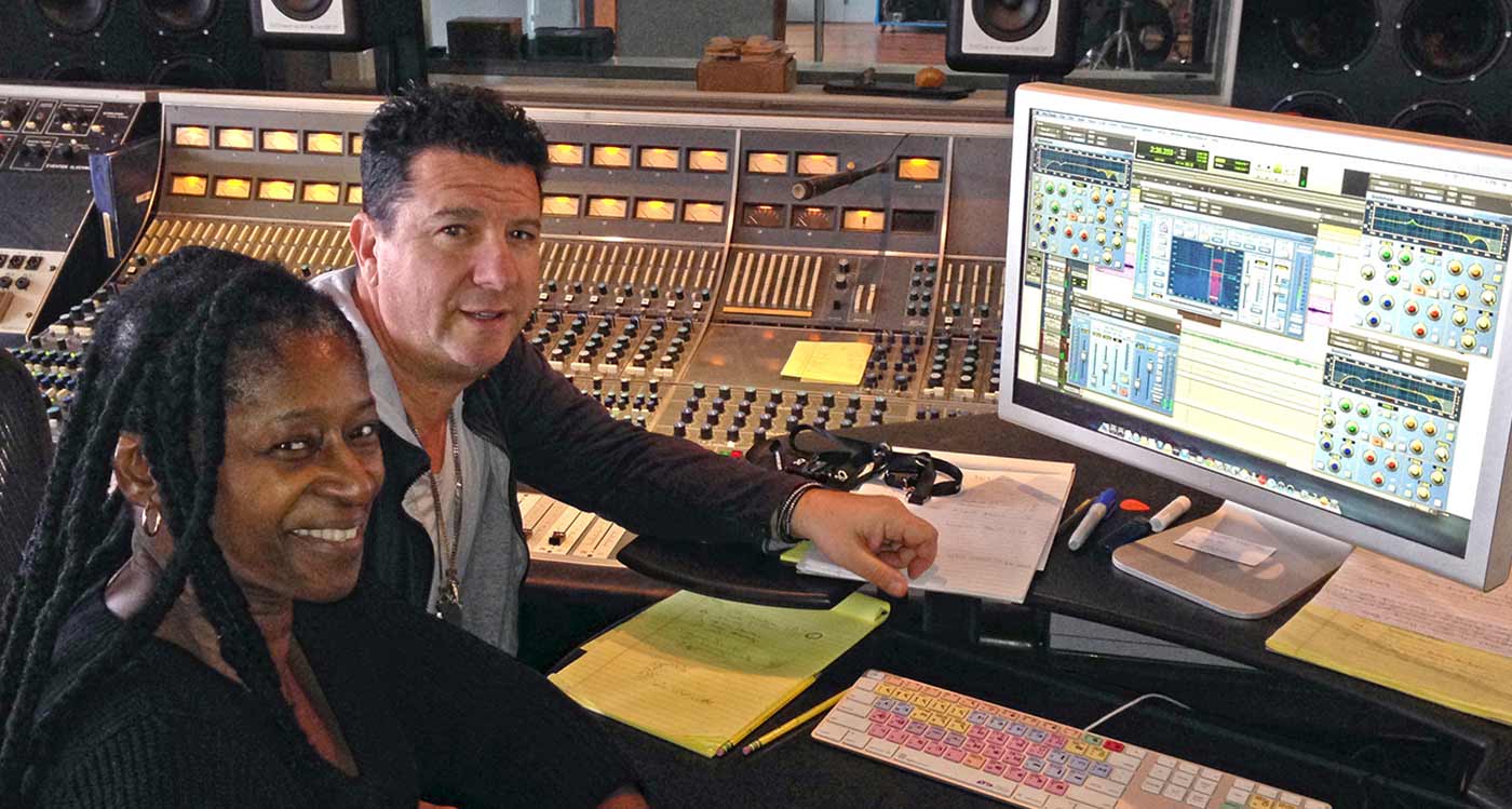 Paul Antonell sat with a client in a mixing studio with Sonnox plugins on the screen