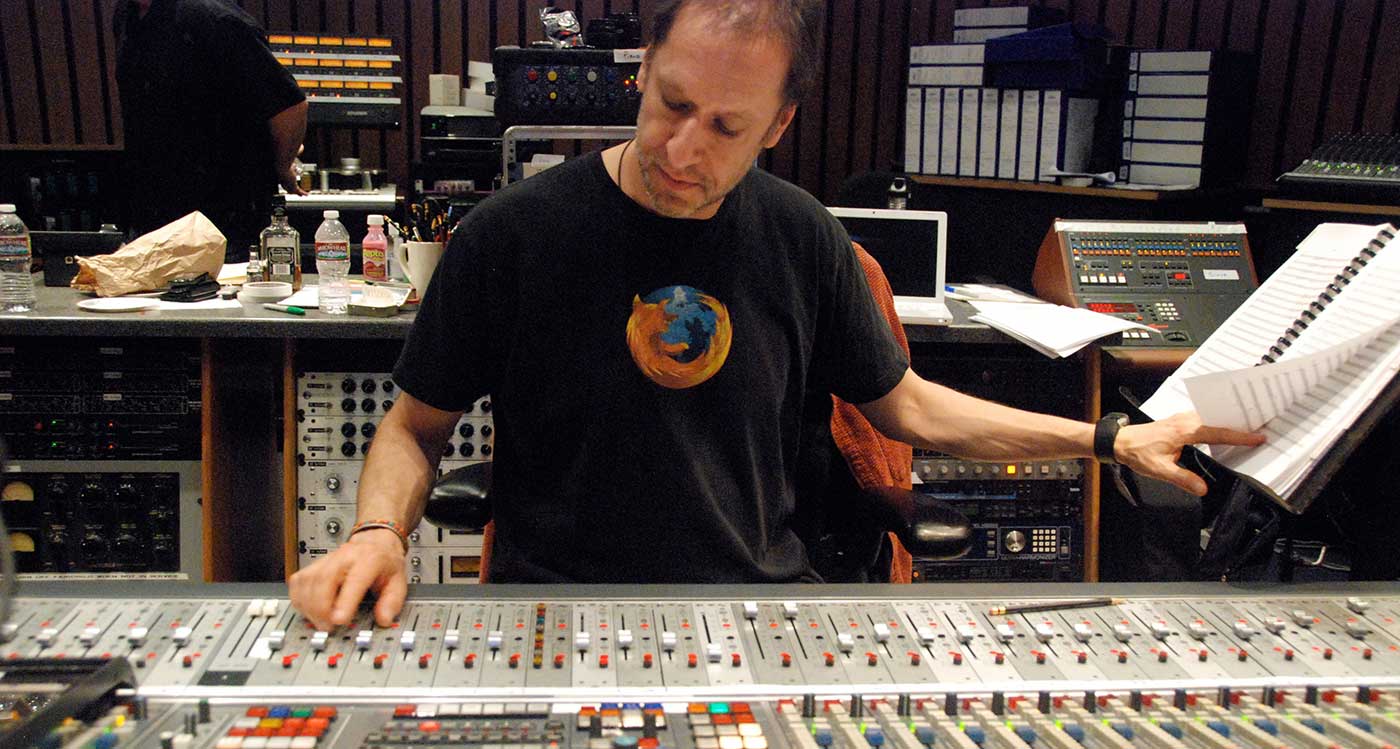 Rich Breen working in recording studio moving a fader on a large mixing console